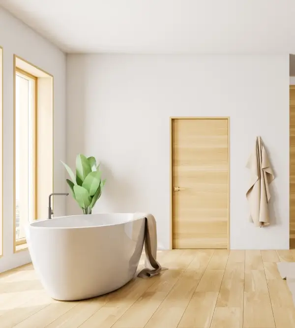 Minimalist bathroom with freestanding bathtub, wooden door, and natural light