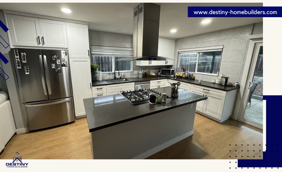 Renovated kitchen of old house with white cabinets, granite countertops, and stainless steel appliances