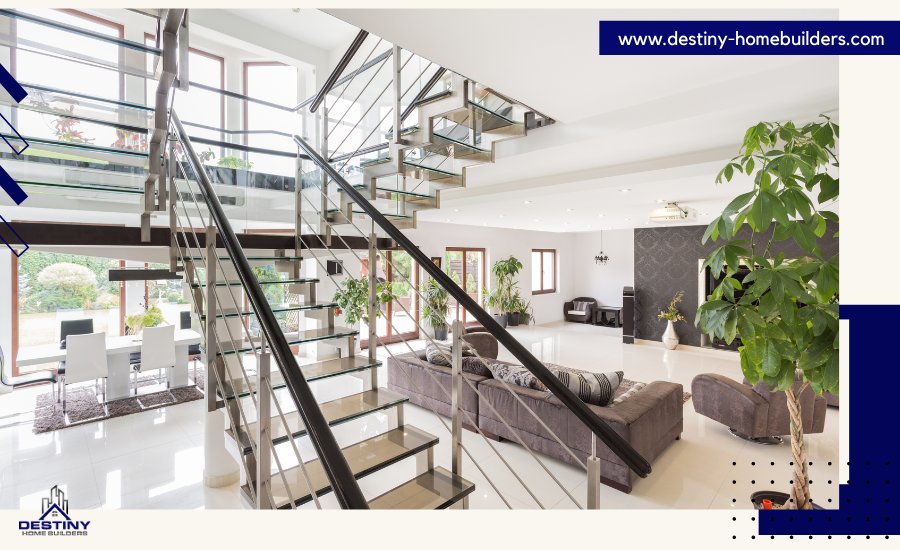 Modern living room with glass staircase, large windows, and open floor plan