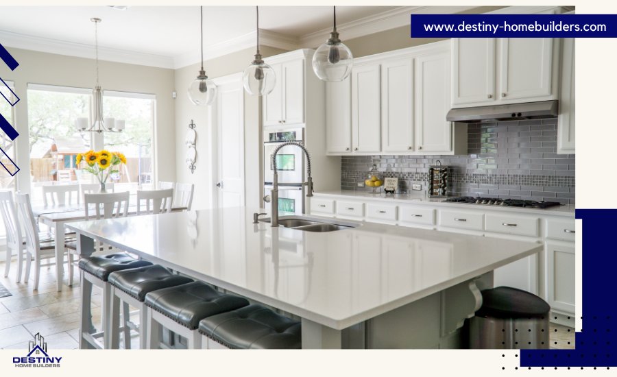 Modern kitchen with white cabinets, quartz countertops, and large island