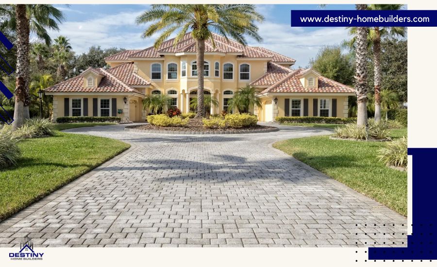 Large, Mediterranean-style old house with brick driveway and palm tree