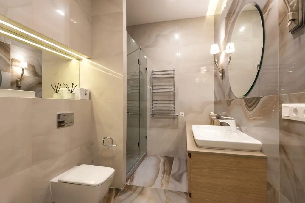 General Contractor in Rancho San Diego upgrading a bathroom with walk-in shower, modern vanity, and elegant tile work