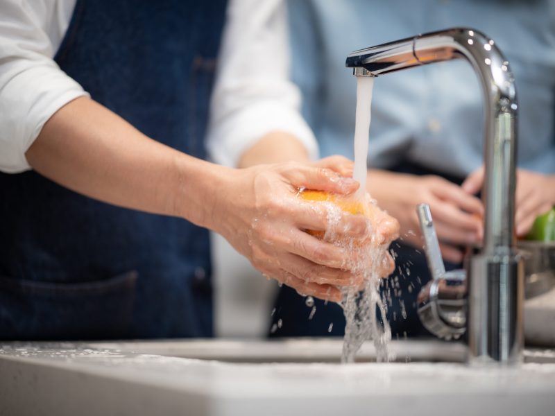 Washing vegetables and fruits for household hygiene.